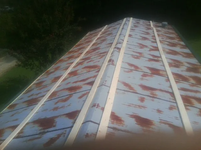 Rusted metal roof panels with new wood purlins before replacement — Storm Damage Roof Repair in Westtown by Roofing Brothers