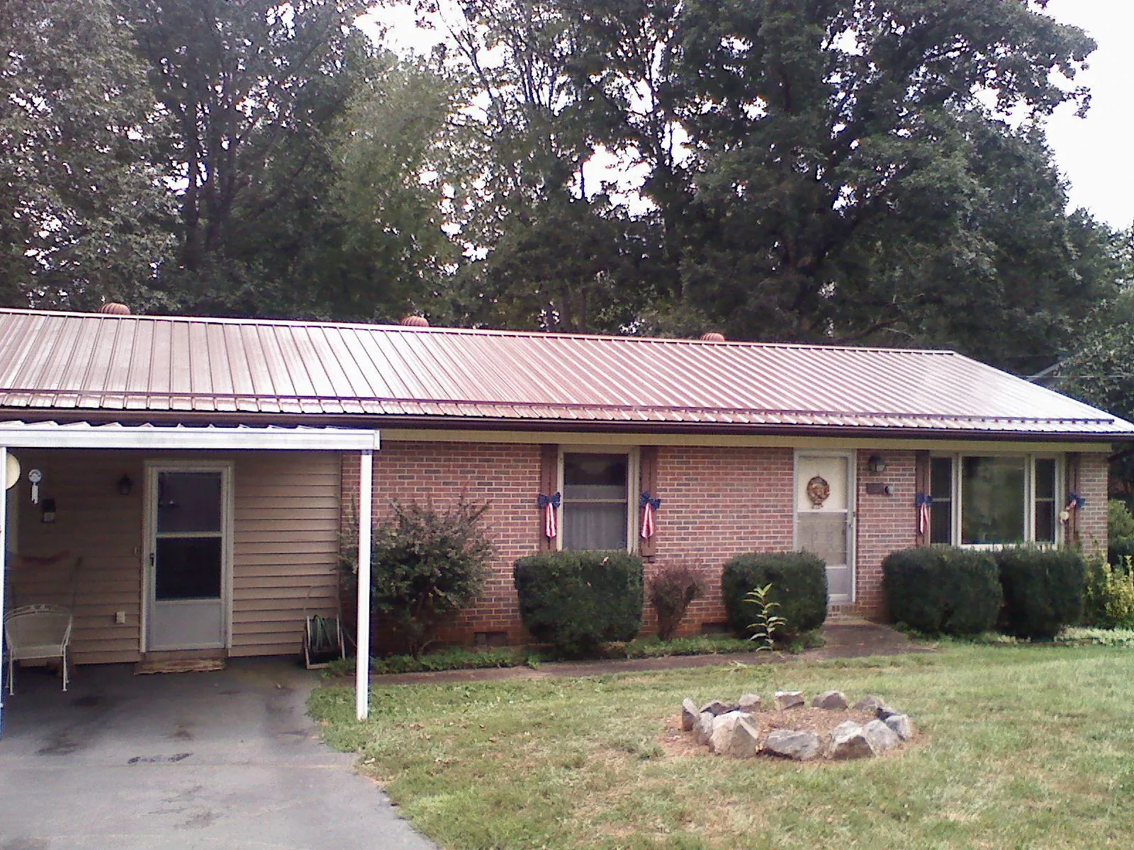 Bronze metal roof and carport on a brick ranch home — Roof Repair work by our crew in Westtown